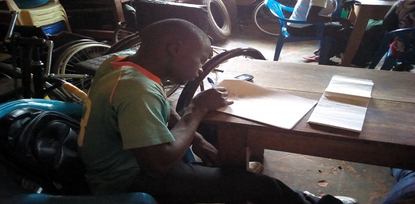 Jokene Geoffry of Tam Anyim Youth Entereprise working on his business plan